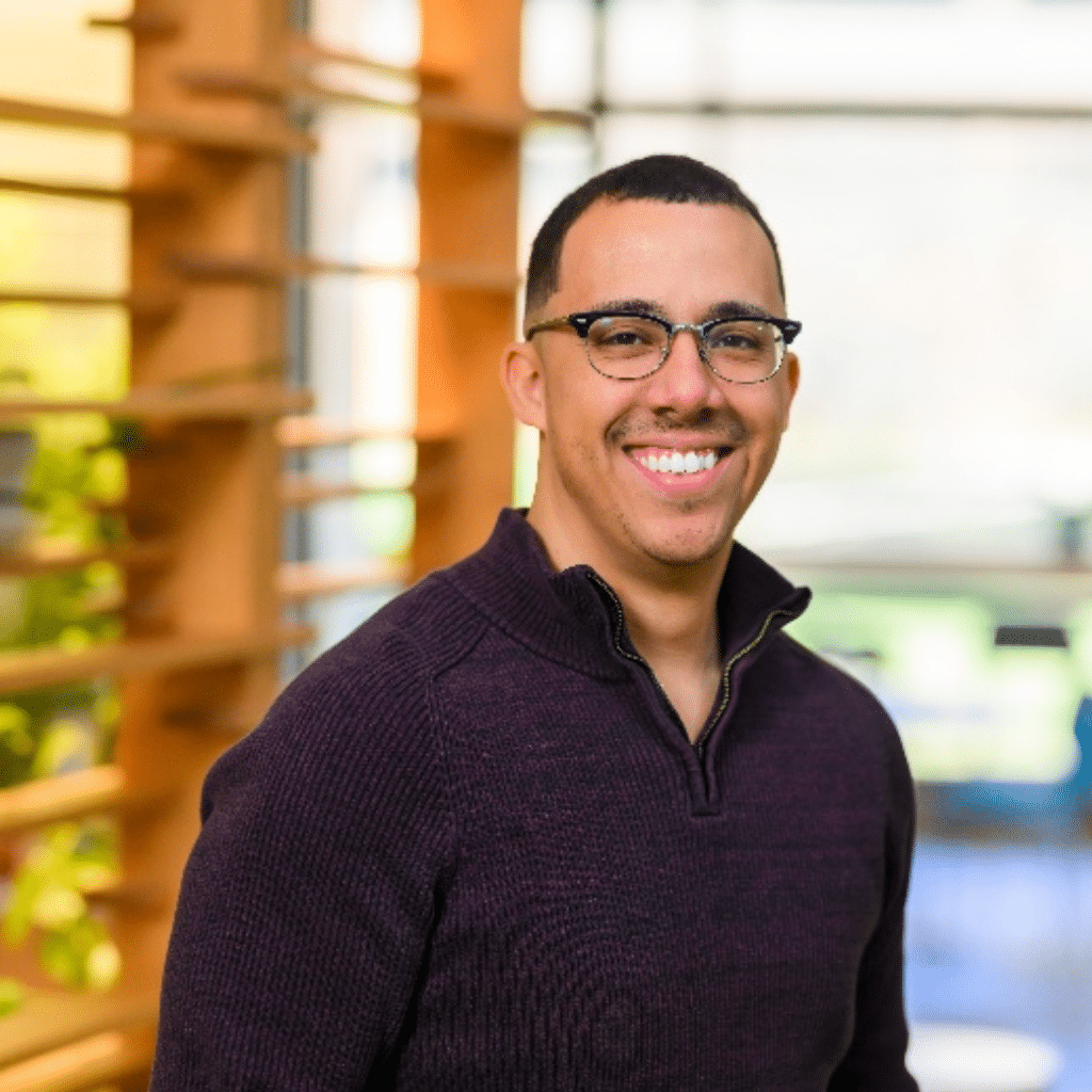 Manny standing in the entry way of the Innovation Space with a dark sweater on.