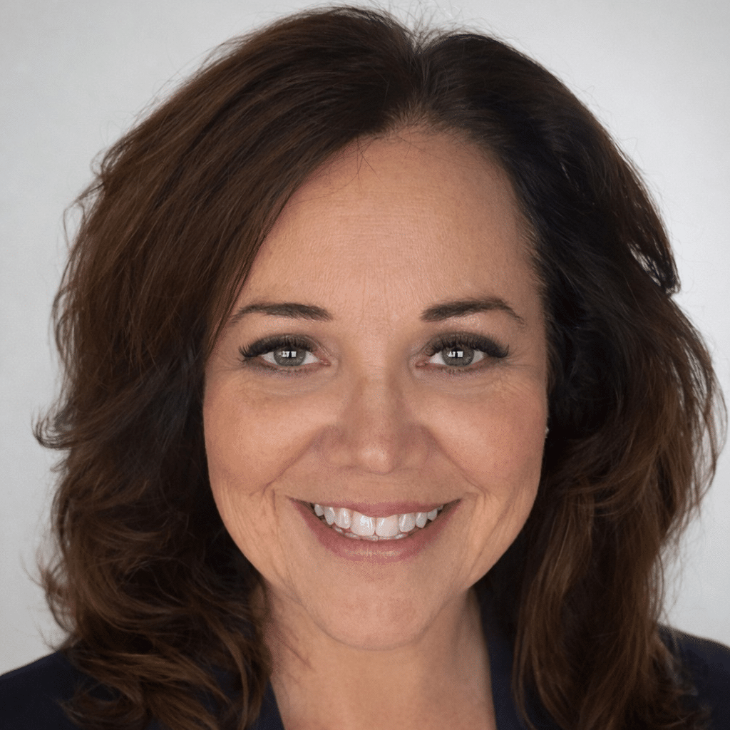 Catherine with brown hair in a black suit jacket.
